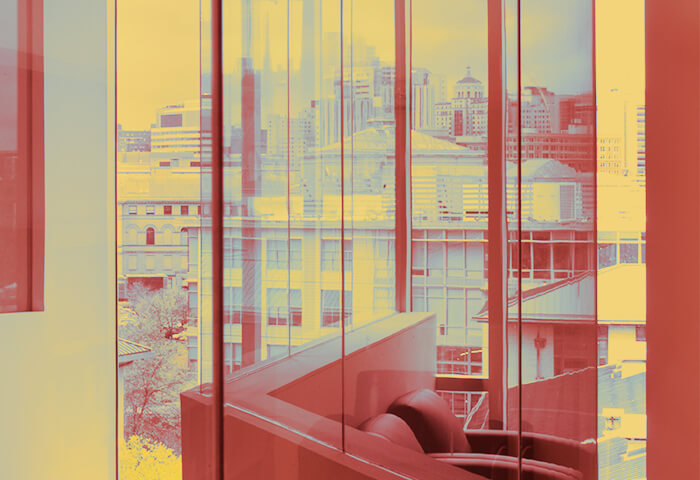 Photo of the view out a window from the Gates-Hillman complex. Photo has been stylized to be red and yellow.