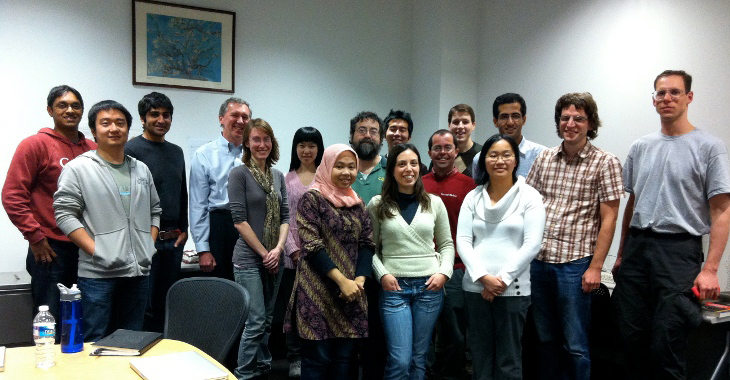 A group of people, including Bryan Kisiel, far right, pose for a photo at the first birthday celebration for the Never-Ending Language Learner.